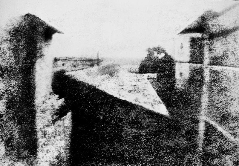View from a window at Le Gras, 1826–27, showing a faint, blurred rural scene with buildings and trees, the world's first permanent photograph